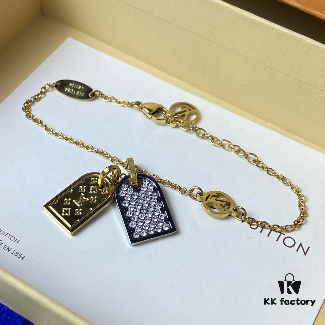A pair of name tags engraved with the classic LV Initials signature, featuring contrasting gold and silver finishes, a soft pearl chain, and a buckle adorned with the LV Circle logo.