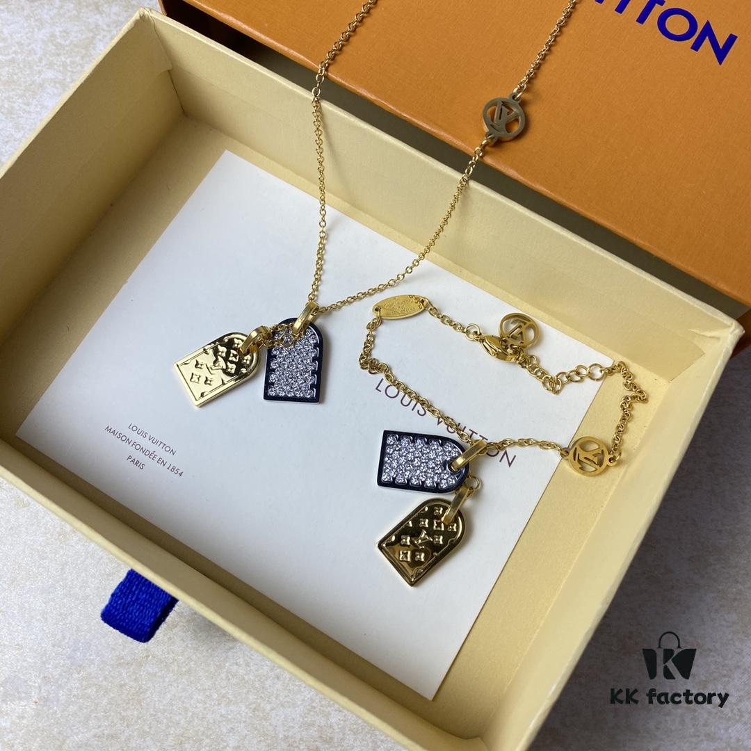 A pair of name tags engraved with the classic LV Initials signature, featuring contrasting gold and silver finishes, a soft pearl chain, and a buckle adorned with the LV Circle logo.