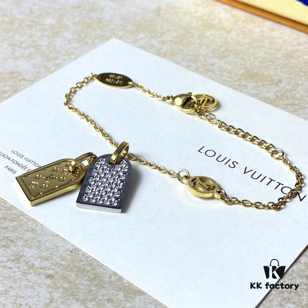 A pair of name tags engraved with the classic LV Initials signature, featuring contrasting gold and silver finishes, a soft pearl chain, and a buckle adorned with the LV Circle logo.