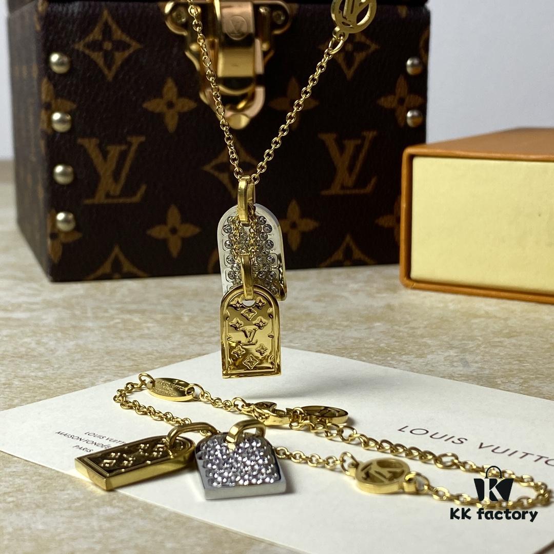 A pair of name tags engraved with the classic LV Initials signature, featuring contrasting gold and silver finishes, a soft pearl chain, and a buckle adorned with the LV Circle logo.