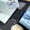 He Fang Aurora Ribbon Knot Collarbone Necklace, Exquisitely Crafted from S925 Silver with Shimmering Diamond Accents and Colorful Iridescent Cube Pendant