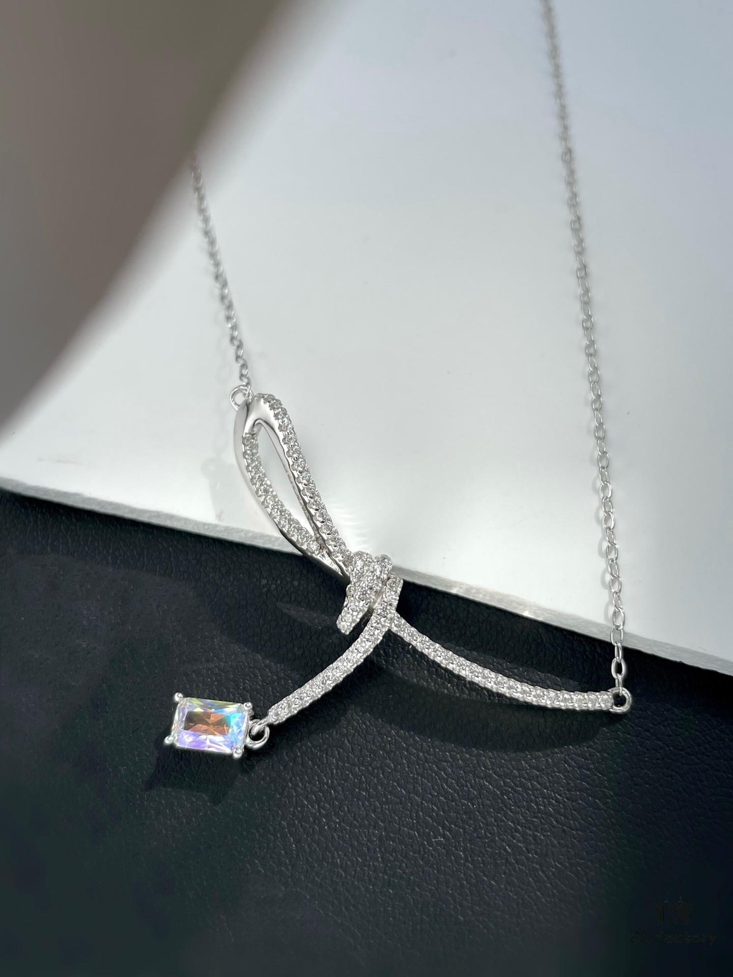 He Fang Aurora Ribbon Knot Collarbone Necklace, Exquisitely Crafted from S925 Silver with Shimmering Diamond Accents and Colorful Iridescent Cube Pendant