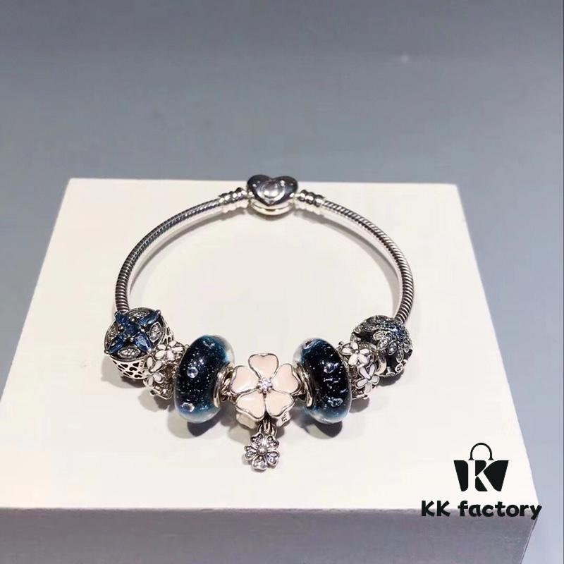 Pandora Night Sky Blue Elegant Pink Flower Design! Crafted with authentic boutique materials, perfectly replicating the original store quality. Features night sky blue bubbled glass, delicate cherry blossom spacers, cross snowflake charm, elegant pink flower accent, and is made of S925 silver, complete with official boutique packaging!
