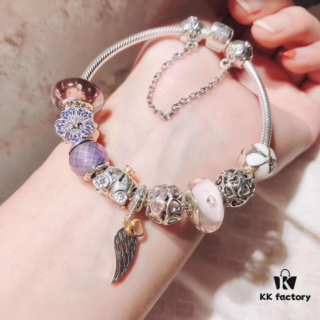 Pandora Pink and Purple Two-Tone Angel Wings New Arrival! Crafted with authentic boutique materials, perfectly replicated to match retail quality. Features pink heart glass beads, purple and brown two-tone glass beads, pumpkin carriage charm, pink heart charm, openwork heart charm, purple five-petal flower charm, and angel wings pendant.