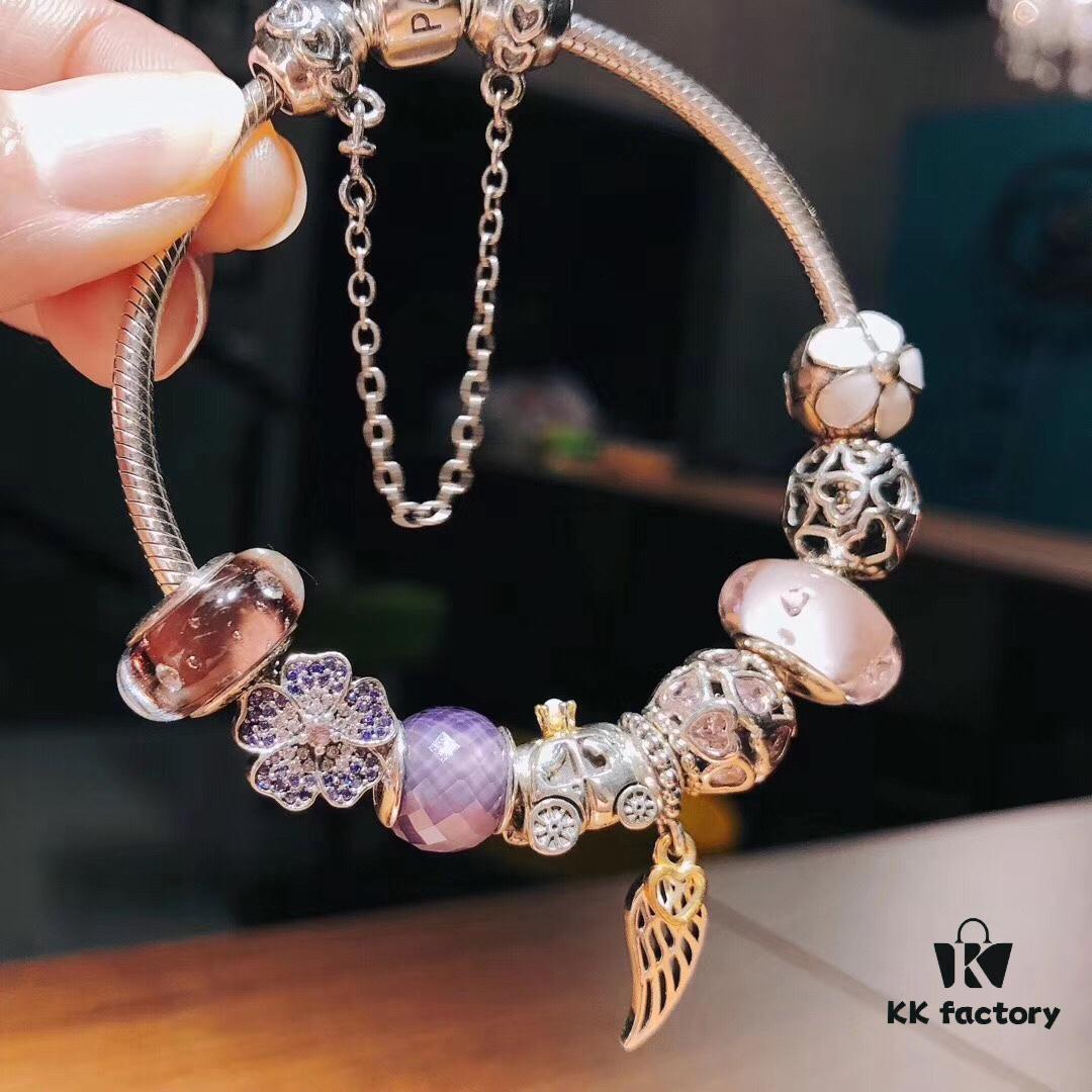 Pandora Pink and Purple Two-Tone Angel Wings New Arrival! Crafted with authentic boutique materials, perfectly replicated to match retail quality. Features pink heart glass beads, purple and brown two-tone glass beads, pumpkin carriage charm, pink heart charm, openwork heart charm, purple five-petal flower charm, and angel wings pendant.