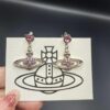 West Dame Saturn Earrings