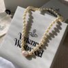Vivienne Westwood Enamel Pearl Necklace with Magnetic Clasp, Double-Sided Wear, Saturn and Crown Design, Elegant and Edgy Style