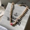 Vivienne Westwood Enamel Pearl Necklace with Magnetic Clasp, Double-Sided Wear, Saturn and Crown Design, Elegant and Edgy Style