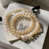 Vivienne Westwood Enamel Pearl Necklace with Magnetic Clasp, Double-Sided Wear, Saturn and Crown Design, Elegant and Edgy Style