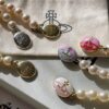 Vivienne Westwood Enamel Pearl Necklace with Magnetic Clasp, Double-Sided Wear, Saturn and Crown Design, Elegant and Edgy Style