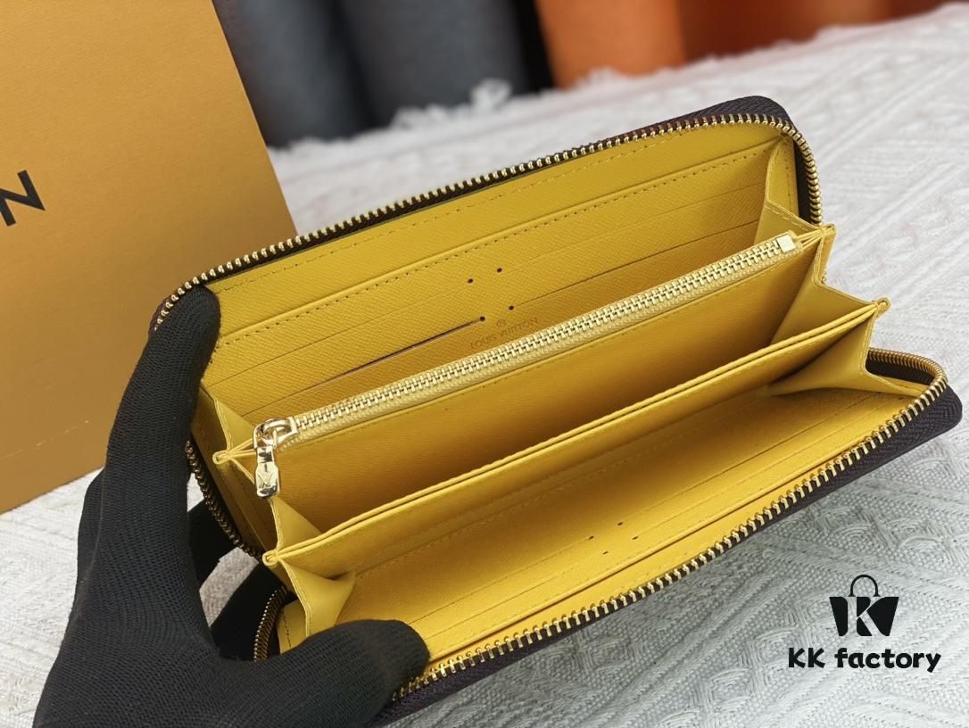 Wallet M80767 Imprint - A collectible multi-compartment zip-around wallet crafted from Monogram canvas, part of the Vivienne Holidays 2022 collection, featuring an exquisite print of Louis Vuitton's mascot Vivienne standing in front of the brand's avant-garde Tokyo boutique with Japan's iconic Mount Fuji in the background. This vibrant and sophisticated wallet serves as an invitation to journey and makes a perfect gift.