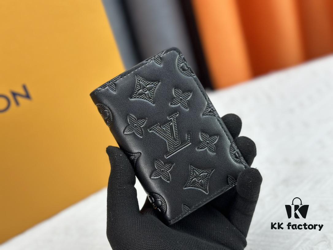 M62899 Wallet: This compact wallet reinterprets the classic design with Monogram Shadow leather. Soft cowhide is embossed with Louis Vuitton's iconic Monogram pattern, while interior compartments and card slots provide organized storage for everyday essentials.