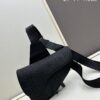 This boxed saddle bag is a new piece from the classic collection, meticulously crafted from black grained leather. A magnetic flap conceals a zip pocket for daily essentials, and it features an adjustable Christian Dior jacquard webbing strap for shoulder or crossbody wear.
