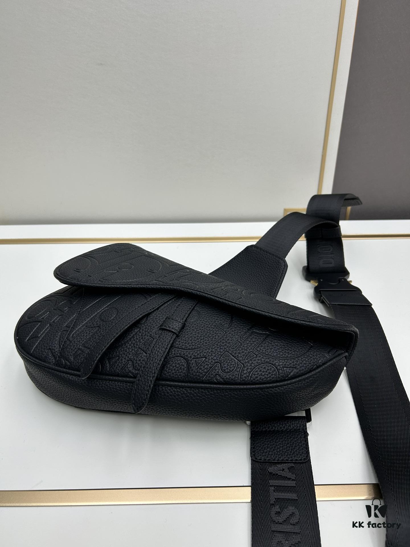 This boxed saddle bag is a new piece from the classic collection, meticulously crafted from black grained leather. A magnetic flap conceals a zip pocket for daily essentials, and it features an adjustable Christian Dior jacquard webbing strap for shoulder or crossbody wear.