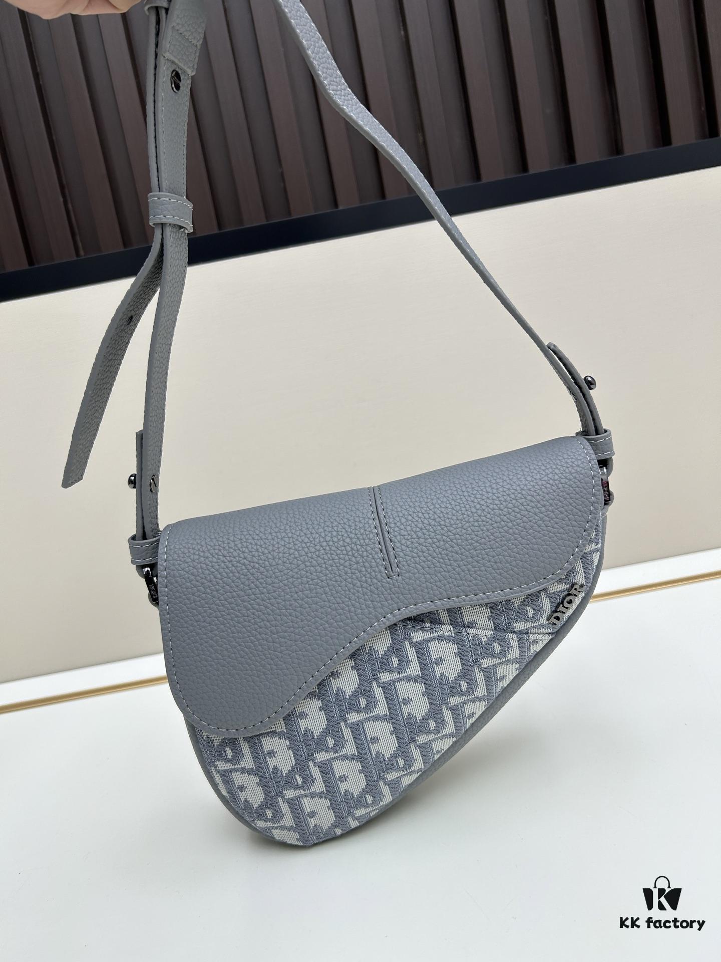 This saddle bag reinterprets the classic design with a modern structure. Crafted from beige and black Oblique print fabric, it features a signature black grained calfskin magnetic flap and a concealed zip closure. The interior includes a large compartment and slip pockets for organizing daily essentials. The mini style comes with an adjustable, detachable leather shoulder strap, allowing for handheld, shoulder, or crossbody wear.