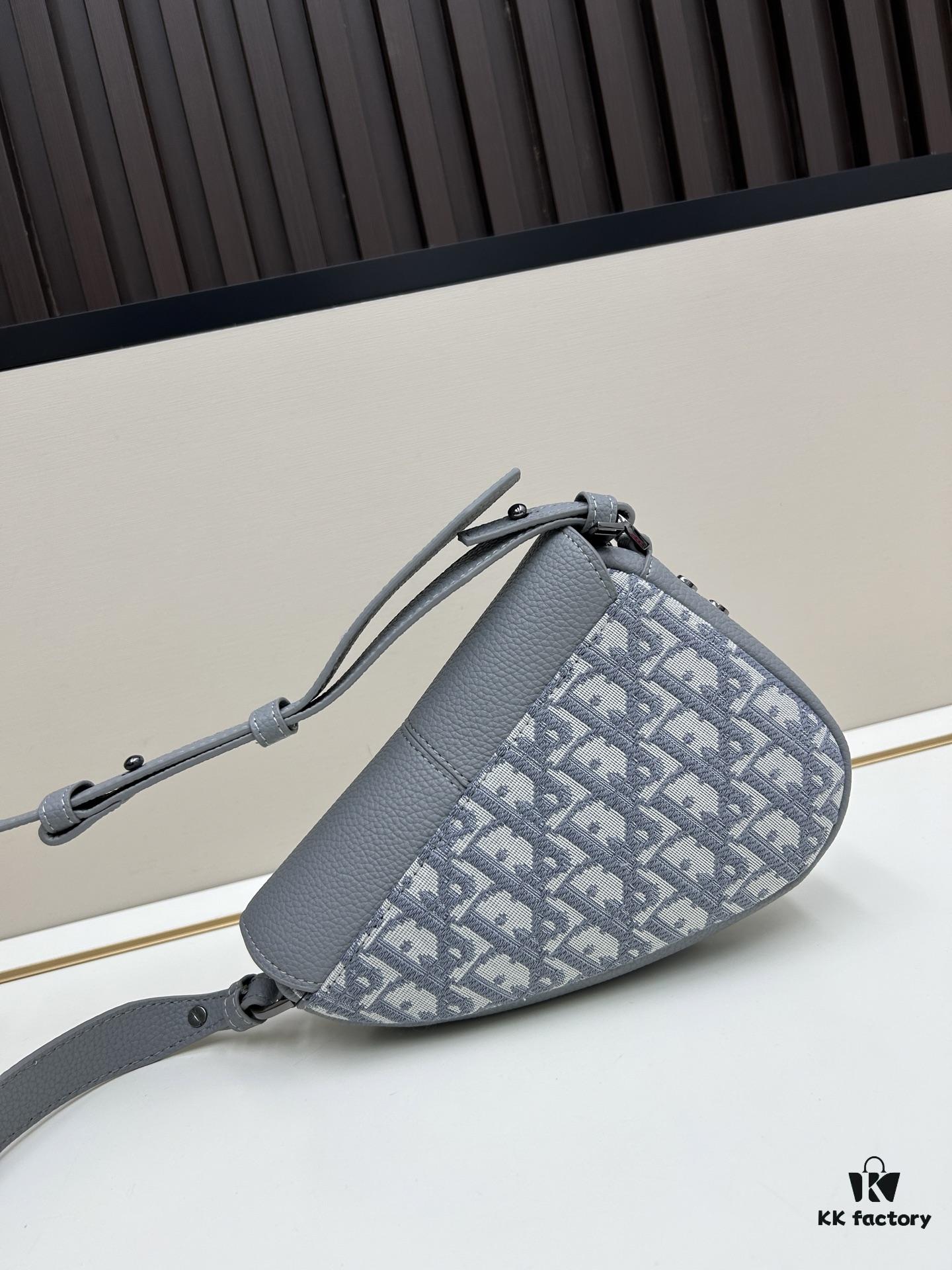 This saddle bag reinterprets the classic design with a modern structure. Crafted from beige and black Oblique print fabric, it features a signature black grained calfskin magnetic flap and a concealed zip closure. The interior includes a large compartment and slip pockets for organizing daily essentials. The mini style comes with an adjustable, detachable leather shoulder strap, allowing for handheld, shoulder, or crossbody wear.