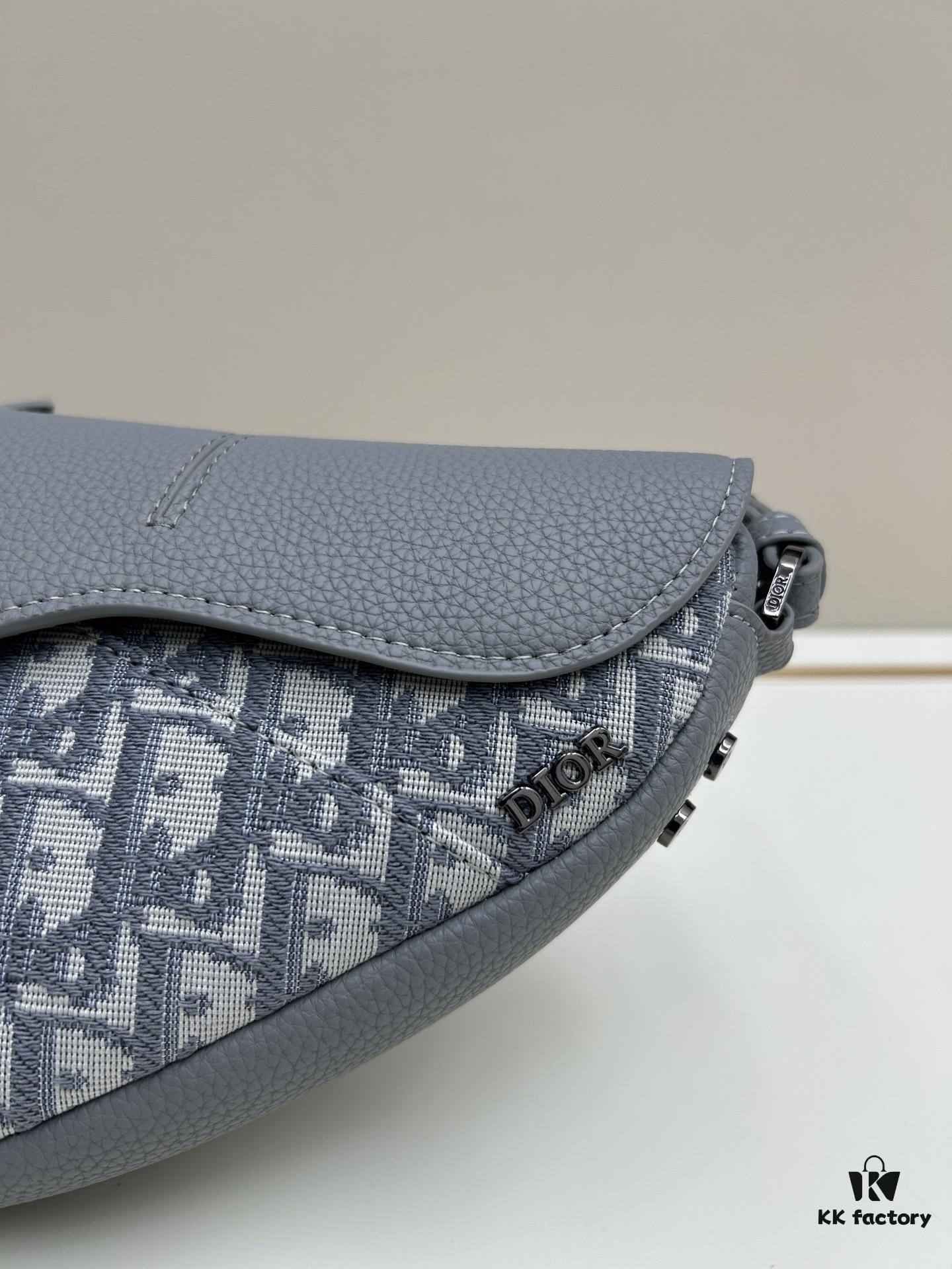 This saddle bag reinterprets the classic design with a modern structure. Crafted from beige and black Oblique print fabric, it features a signature black grained calfskin magnetic flap and a concealed zip closure. The interior includes a large compartment and slip pockets for organizing daily essentials. The mini style comes with an adjustable, detachable leather shoulder strap, allowing for handheld, shoulder, or crossbody wear.