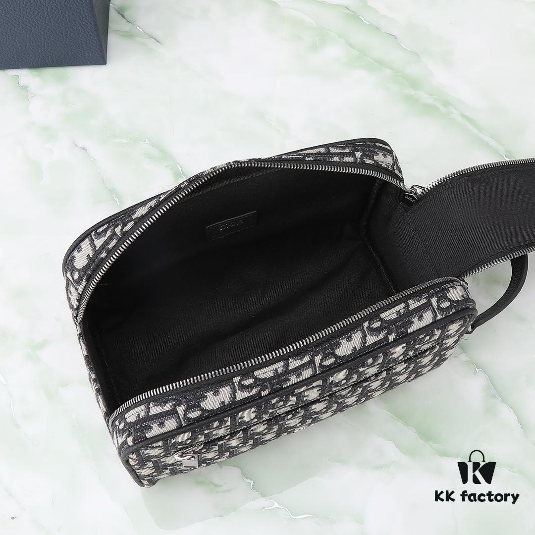 This toiletry bag combines practical functionality with minimalist design, crafted in beige and black Oblique printed fabric with black grained leather trims, featuring the Dior logo on the front.