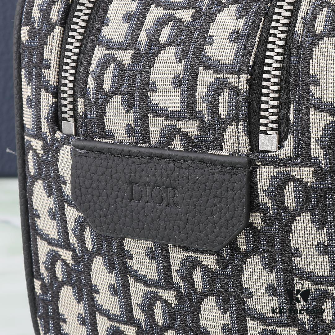 This toiletry bag combines practical functionality with minimalist design, crafted in beige and black Oblique printed fabric with black grained leather trims, featuring the Dior logo on the front.