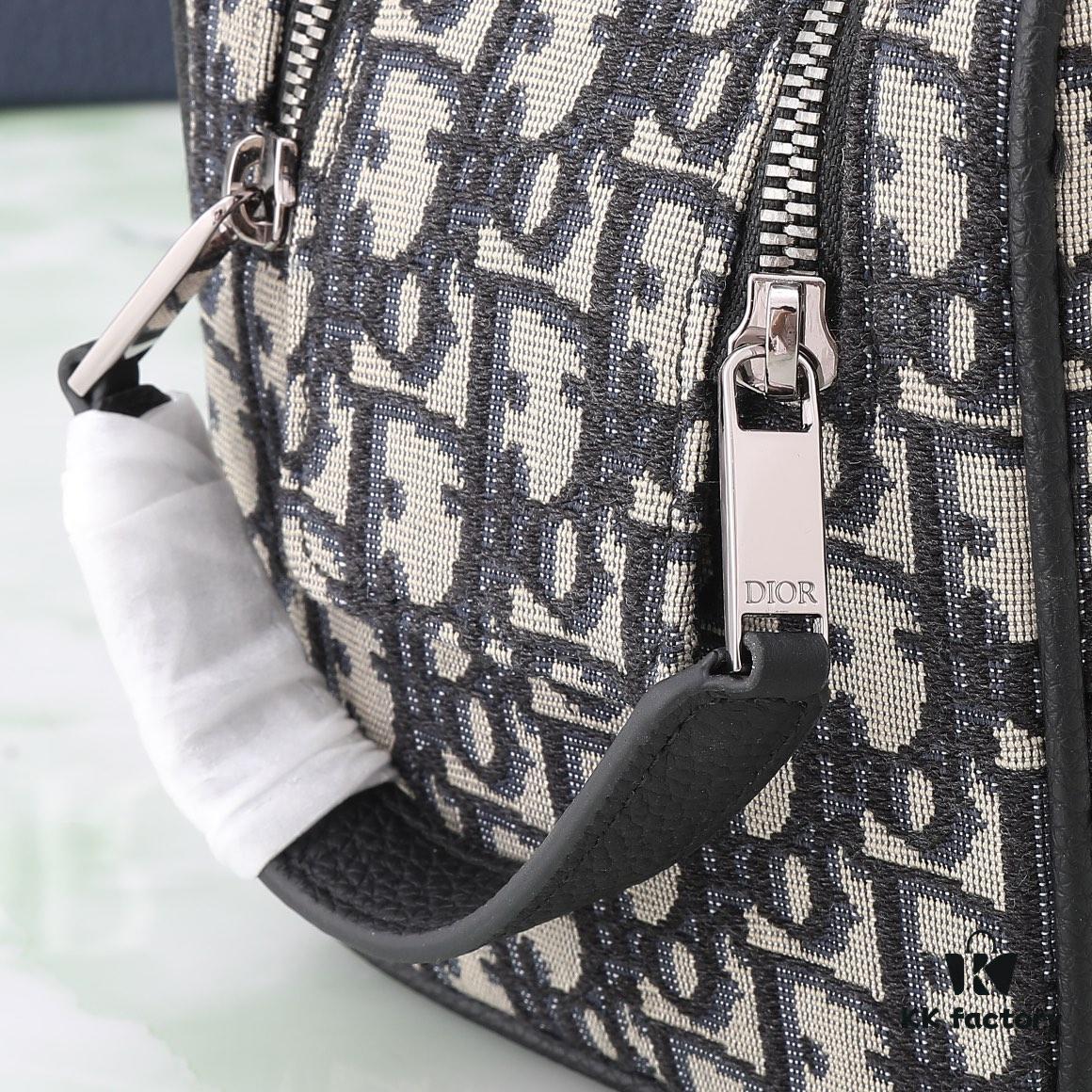 This toiletry bag combines practical functionality with minimalist design, crafted in beige and black Oblique printed fabric with black grained leather trims, featuring the Dior logo on the front.