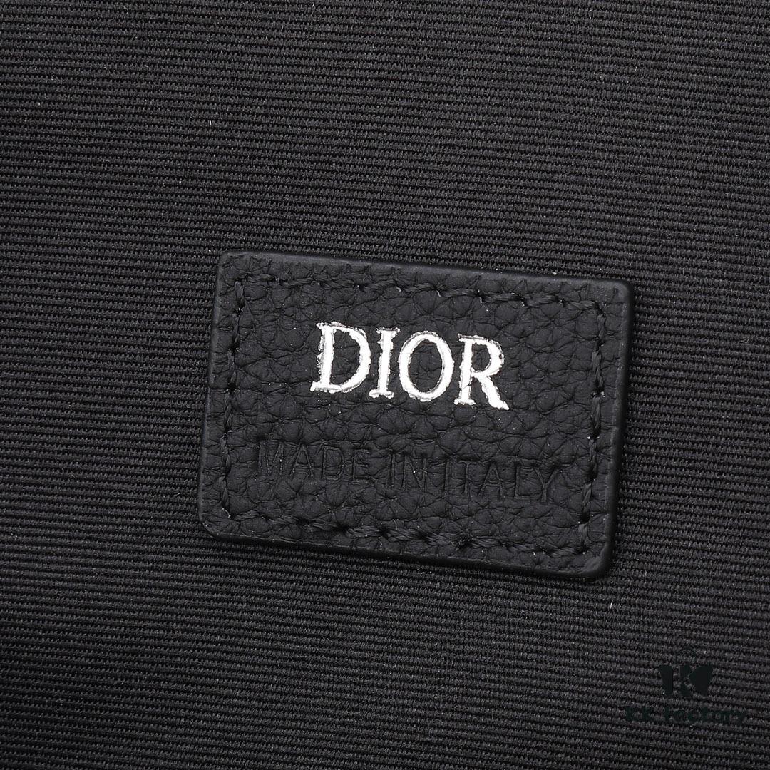 This toiletry bag combines practical functionality with minimalist design, crafted in beige and black Oblique printed fabric with black grained leather trims, featuring the Dior logo on the front.