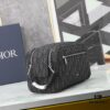This toiletry bag combines practical functionality with minimalist design. Crafted from black Oblique-print fabric, it features grained calfskin leather trims in matching tones and is adorned with a Dior signature on the front. The front features a zip pocket, a spacious main zipped compartment, and two slip pockets. Equipped with a leather handle, it can be carried by hand or stored inside various handbags.