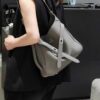New Balenciaga Winter 24 Collection Re-See Shoulder Bucket Bag, Top-Grain Leather, Minimalist Luxury Design, Upcycled Motorbike Glove Handbag with Keychain Closure, Effortless Chic Style