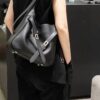 New Balenciaga Winter 24 Collection Re-See Shoulder Bucket Bag, Top-Grain Leather, Minimalist Luxury Design, Upcycled Motorbike Glove Handbag with Keychain Closure, Effortless Chic Style
