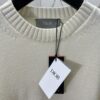 Dior 25SS New Arrival Knitwear from the DIOR AND KAWS Limited Edition Collection. Crafted from white and yellow wool knit fabric, one sleeve features the DIOR AND KAWS signature embroidery, reinterpreting the Dior logo with a colorful serpentine design. The hem and cuffs are finished with contrasting details, perfect for pairing with classic jeans or shorts to create a striking look.