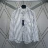 Dior 24SS New Arrival Shirt Featured in Dior's Winter 2024 Men's Collection Show, Fashionably Tailored to Highlight Workwear Aesthetics, Crafted from Blue Striped Cotton Fabric with a Christian Dior Couture Embroidered Chest Pocket, Oversized Fit for a Casual Style