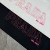 PRAD* Prada 25s New Arrival Unisex T-Shirt with Embroidered Back Logo, Contrast Pink Design, Triangle Metal Badge on Chest, 280g Pure Cotton Fabric, Classic Brand Lettering, High-Fashion Streetwear