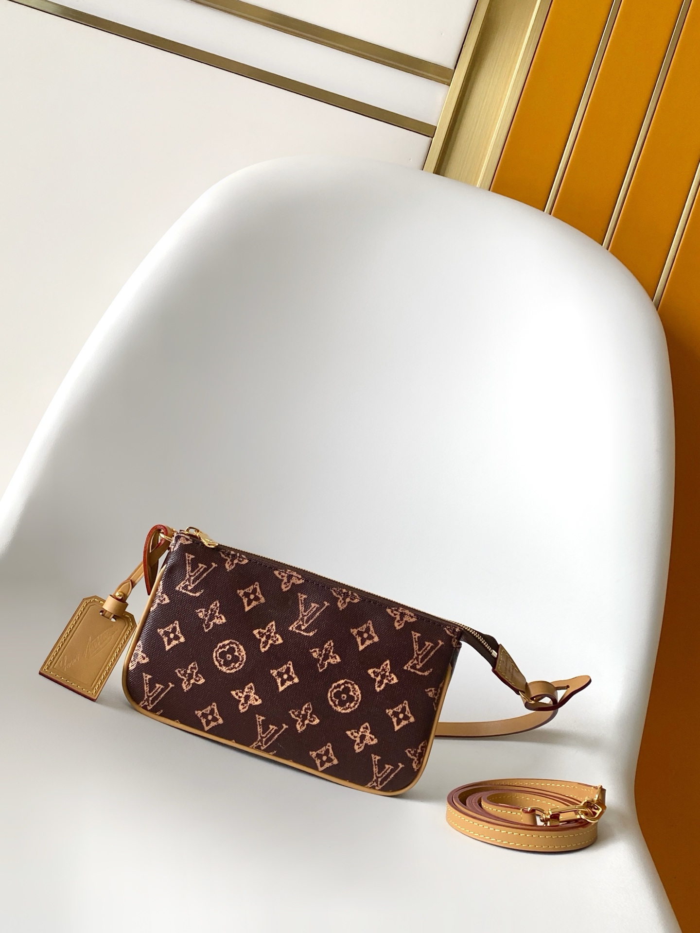Louis Vuitton This Pochette Accessoires handbag is specially designed to celebrate the birth of the Louis Vuitton Monogram pattern.