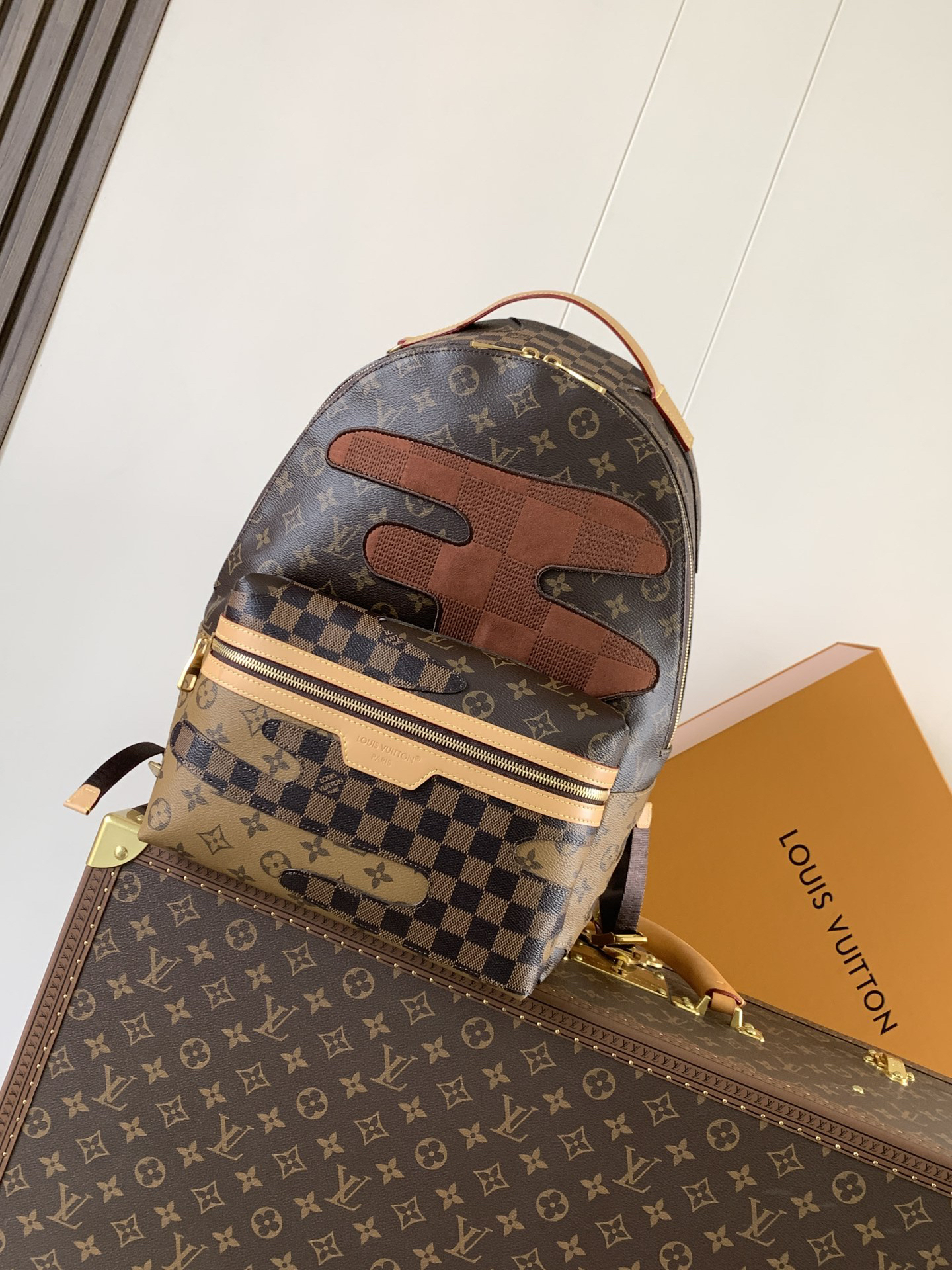 Louis Vuitton This Discovery Small Backpack features Monogram canvas accented with Monogram Reverse and Damier canvas patches.