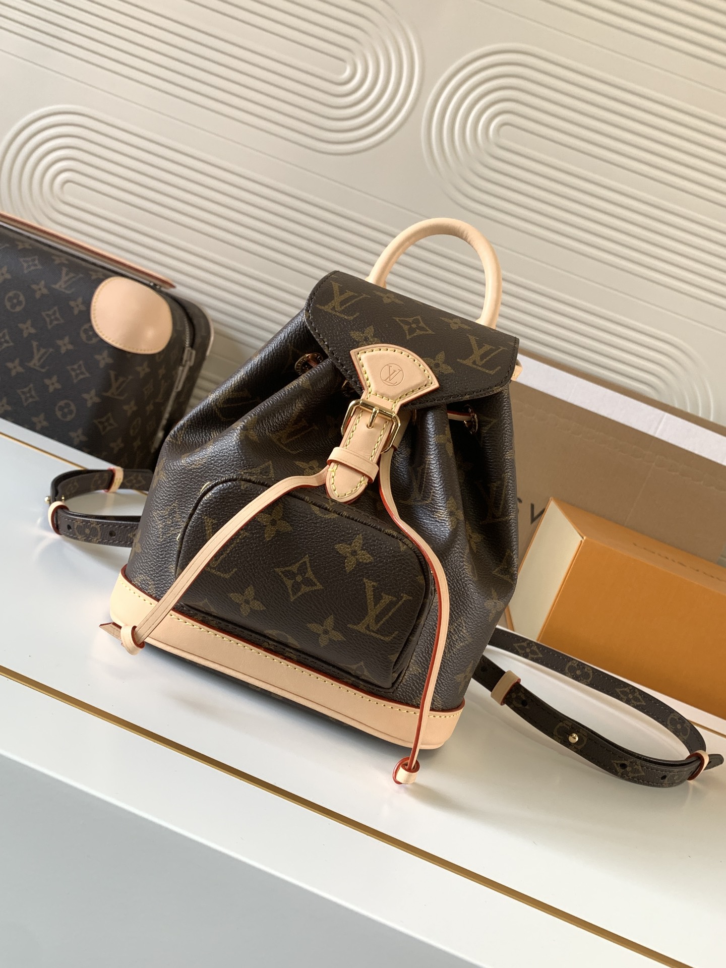 Louis Vuitton This Montsouris Mini features Monogram coated canvas with cowhide leather trim.