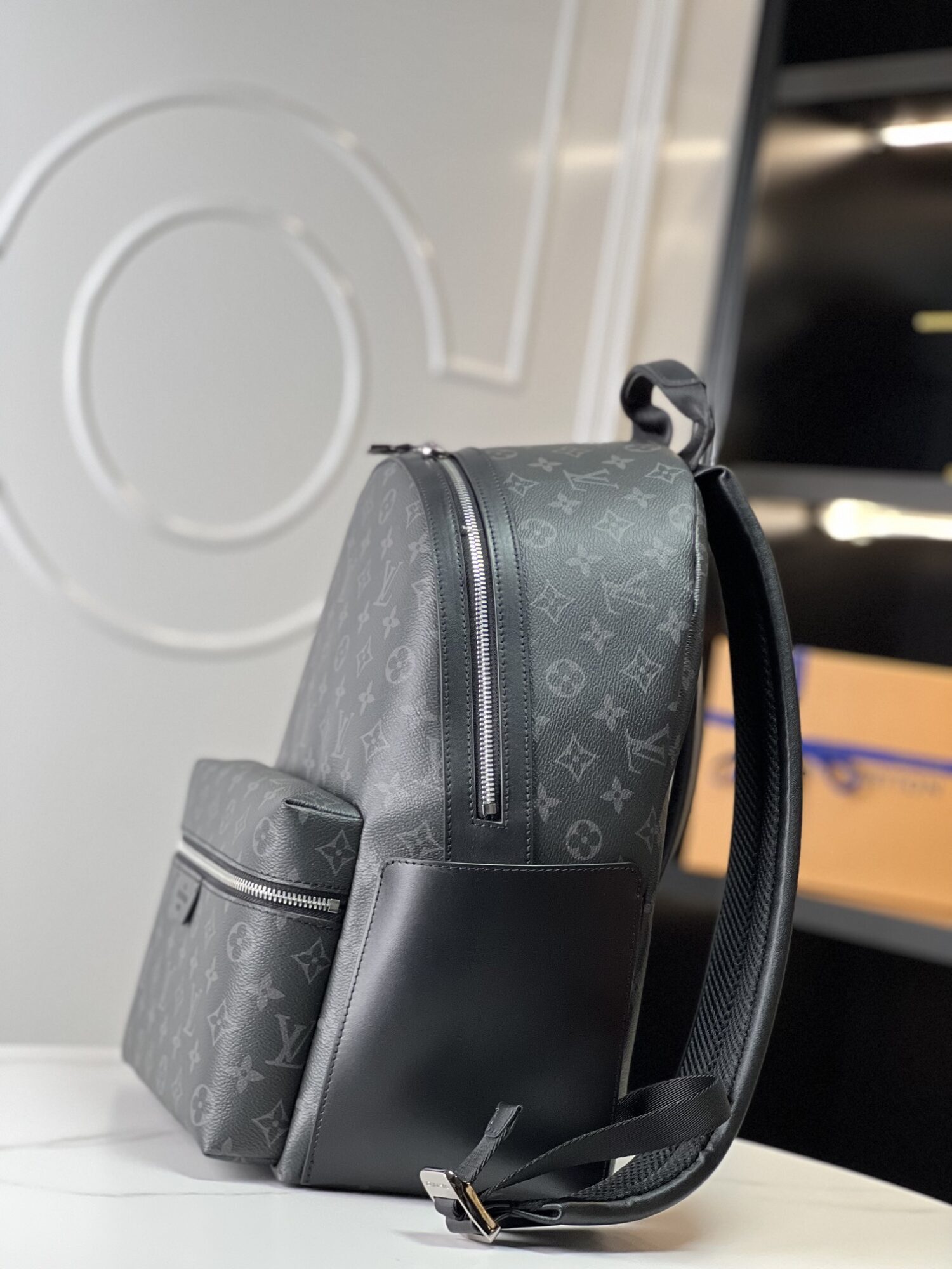 Crafted from Monogram Eclipse canvas, this small Discovery backpack retains its versatile functionality in a more compact silhouette.