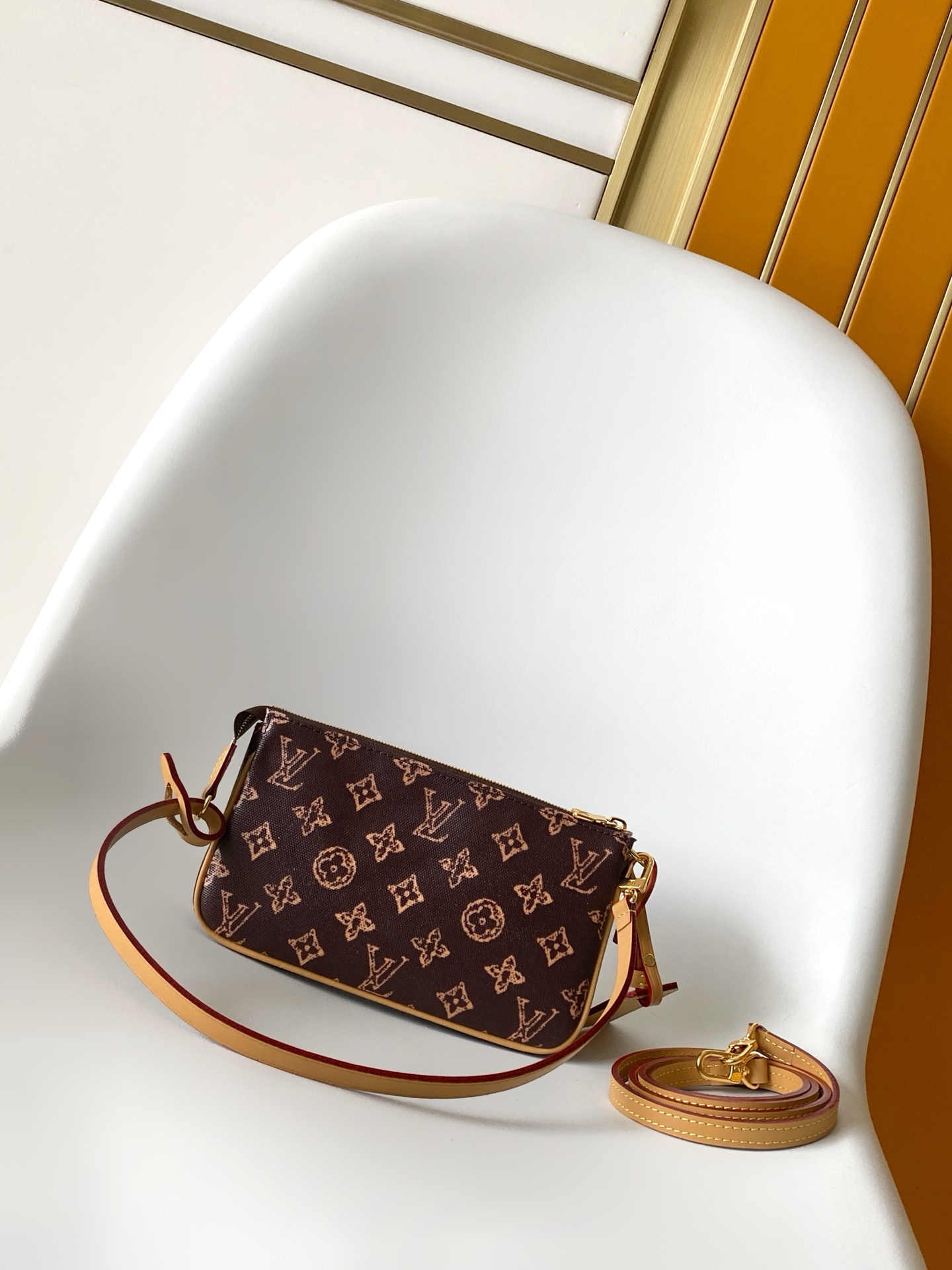 Louis Vuitton This Pochette Accessoires handbag is specially designed to celebrate the birth of the Louis Vuitton Monogram pattern.