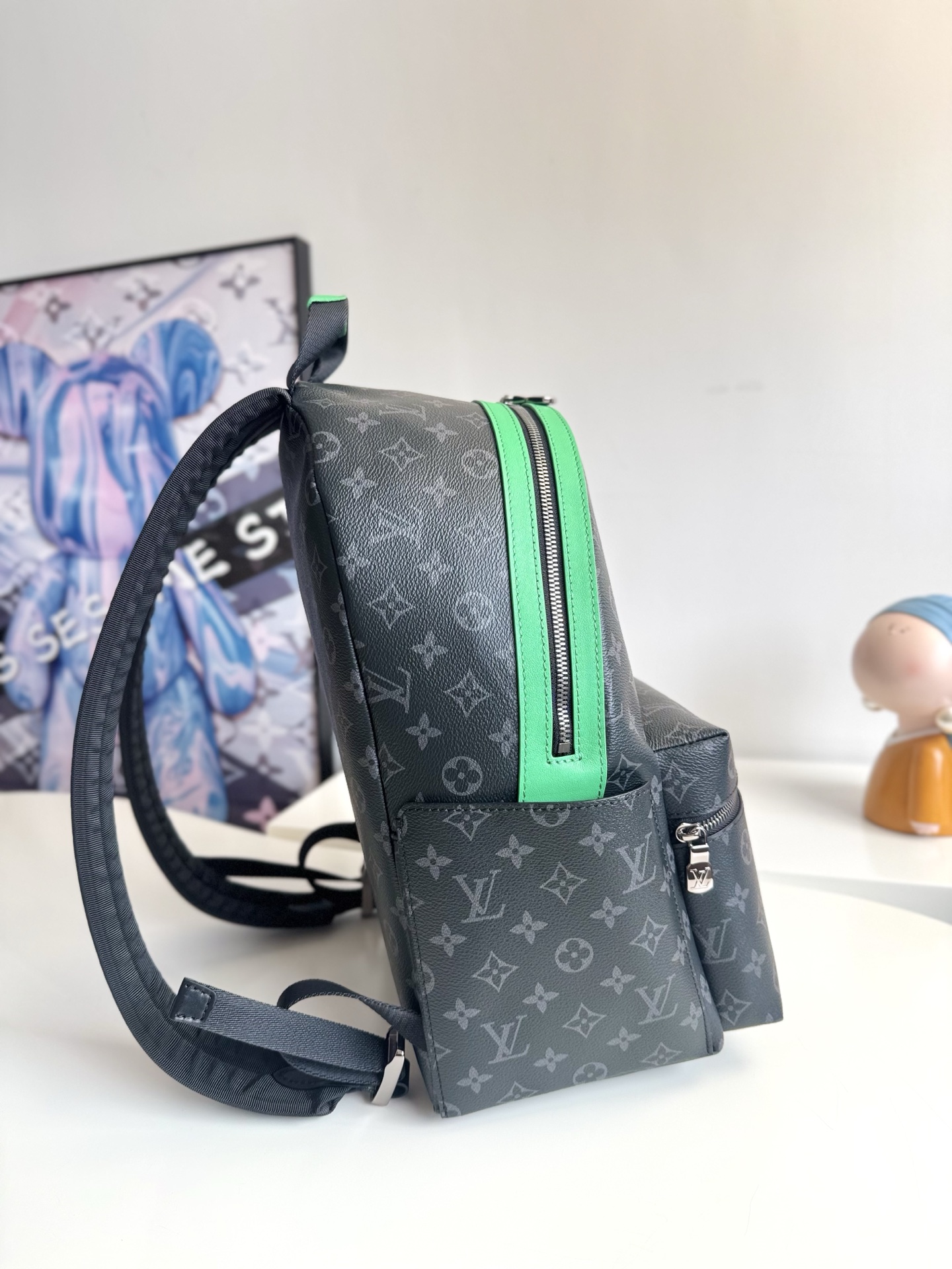 Louis Vuitton This small Discovery backpack features a patchwork of Monogram Eclipse canvas and vibrant cowhide leather.