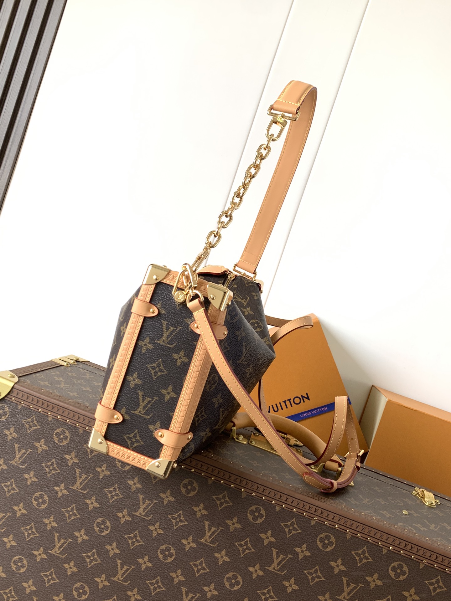 Louis Vuitton This large Side Trunk handbag features Monogram canvas accented with contrasting leather trim.
