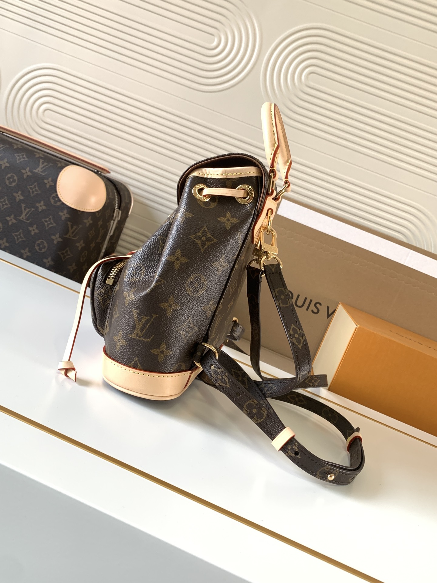 Louis Vuitton This Montsouris Mini features Monogram coated canvas with cowhide leather trim.