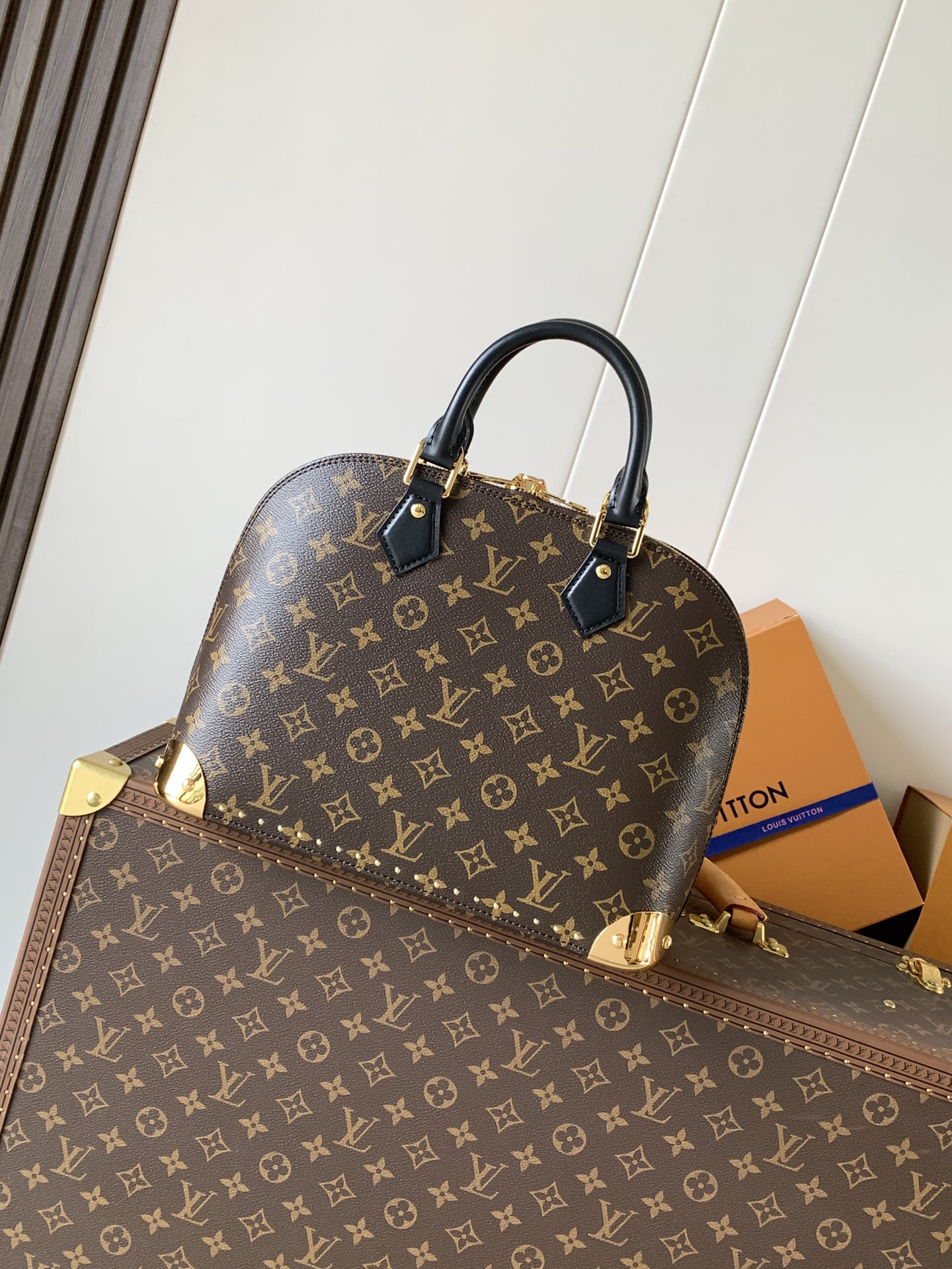 Louis Vuitton The Trunk collection welcomes a contemporary new iteration of the Alma Small handbag, paying homage to the brand's travel heritage with exquisite metal hardware.