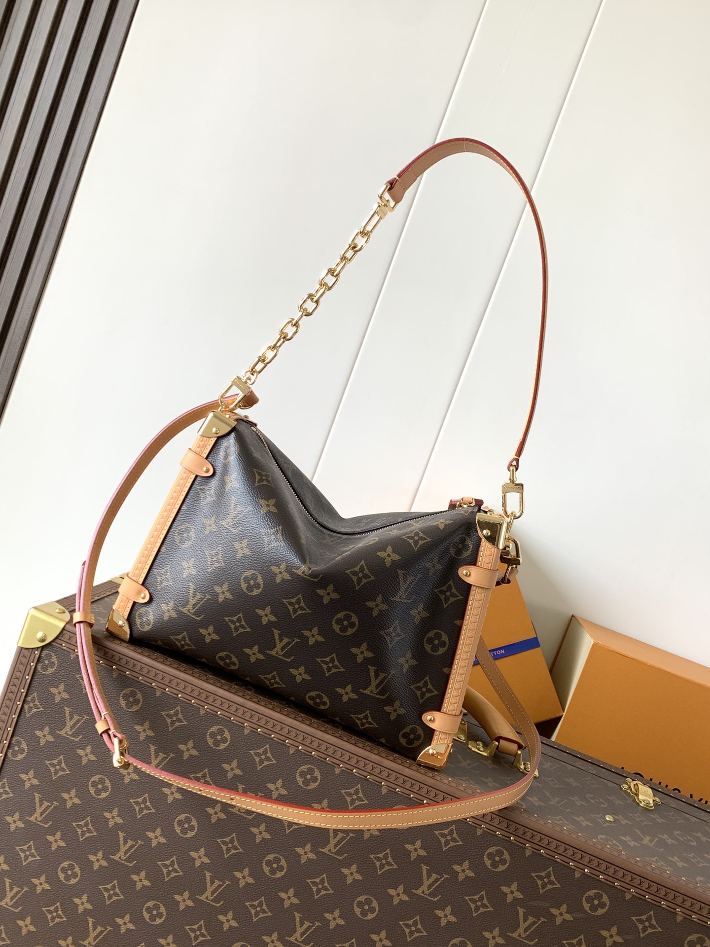 Louis Vuitton This large Side Trunk handbag features Monogram canvas accented with contrasting leather trim.
