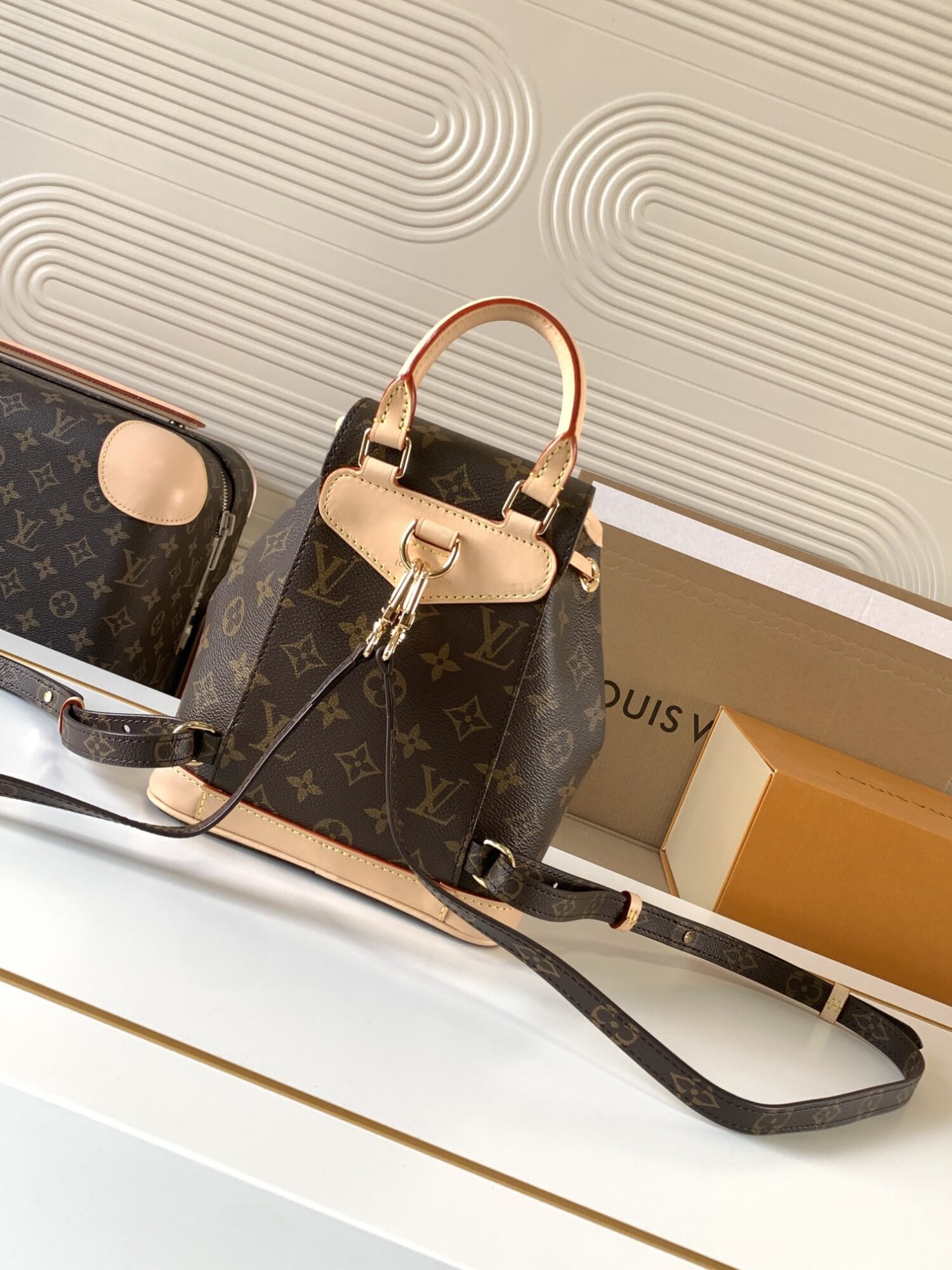 Louis Vuitton This Montsouris Mini features Monogram coated canvas with cowhide leather trim.