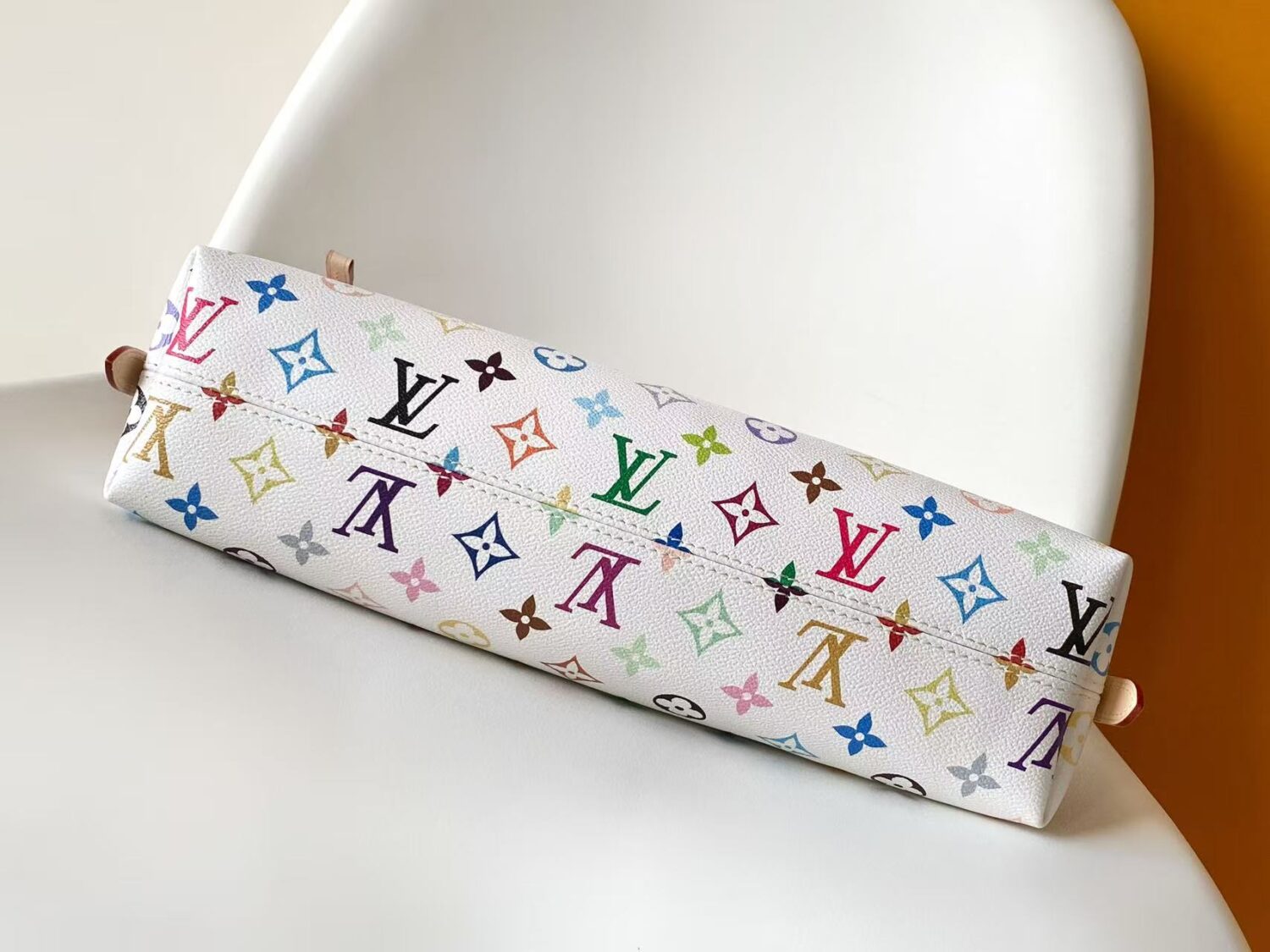 Louis Vuitton This Carryall East-West canvas handbag illuminates this classic element with a vibrant splash of color.