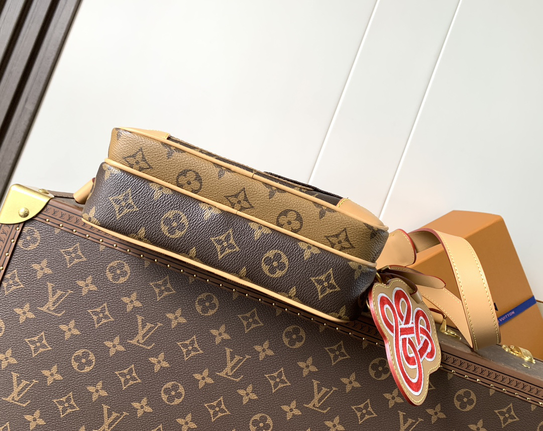Louis Vuitton This Nil messenger bag features a Monogram canvas body accented with Damier and Monogram Reverse canvas patches, creating an elegant patchwork effect.