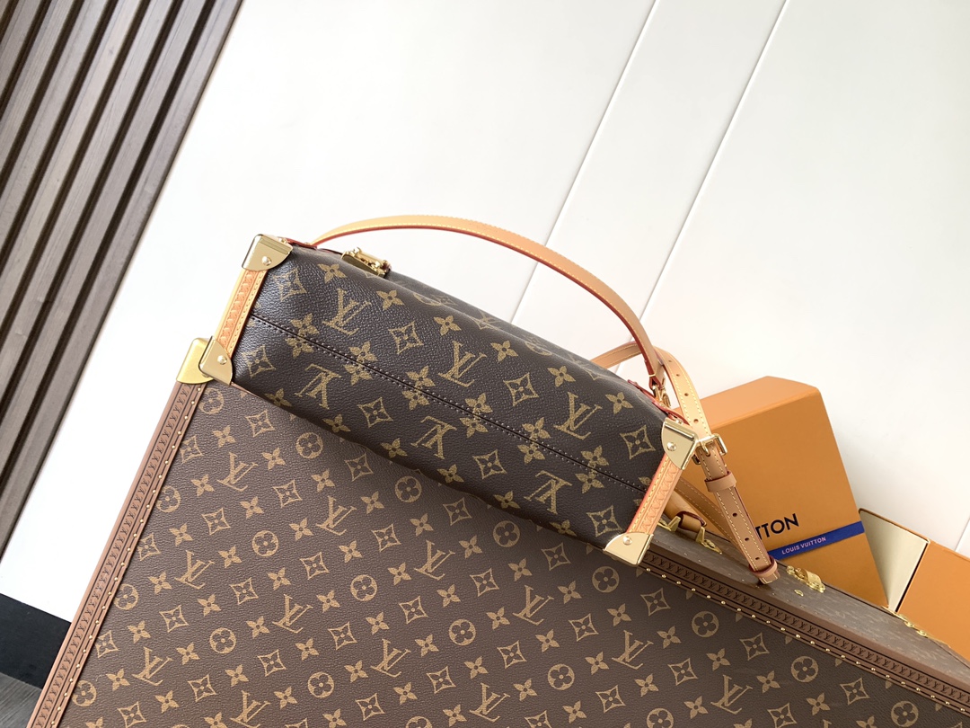 Louis Vuitton This large Side Trunk handbag features Monogram canvas accented with contrasting leather trim.
