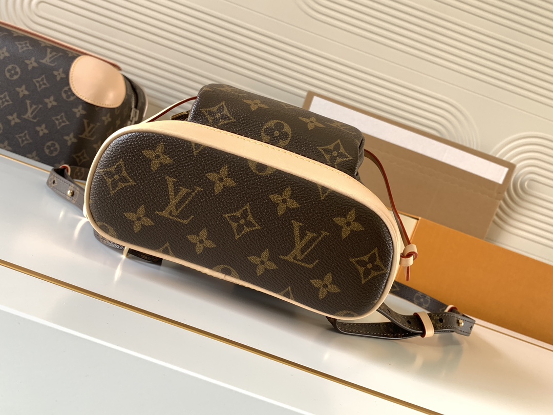 Louis Vuitton This Montsouris Mini features Monogram coated canvas with cowhide leather trim.