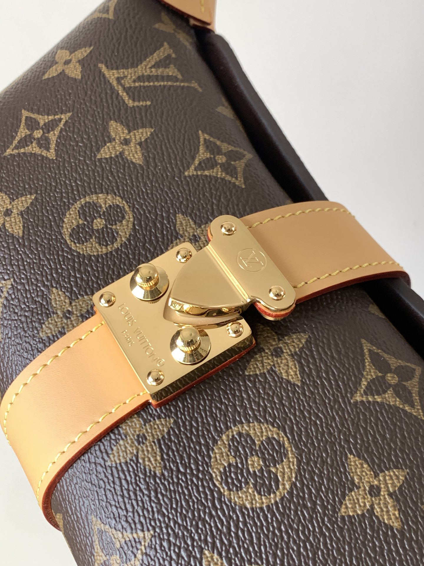 Louis Vuitton This Pochette Mia handbag, part of the Monogram collection, features a Monogram canvas body accented with cowhide leather trim.
