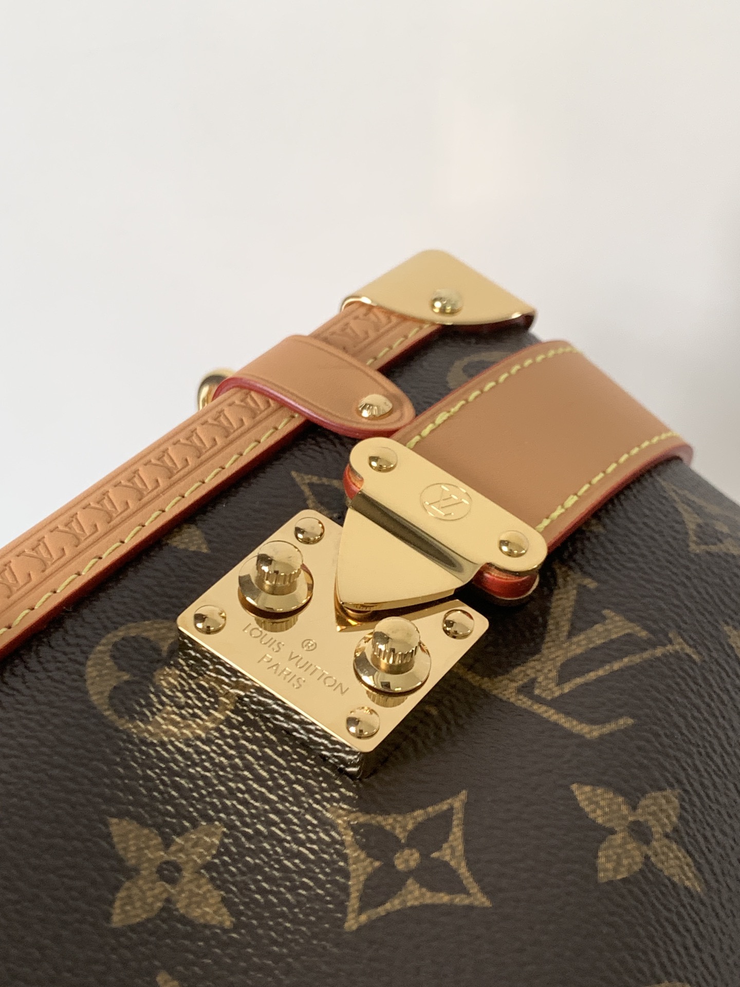 Louis Vuitton This large Side Trunk handbag features Monogram canvas accented with contrasting leather trim.