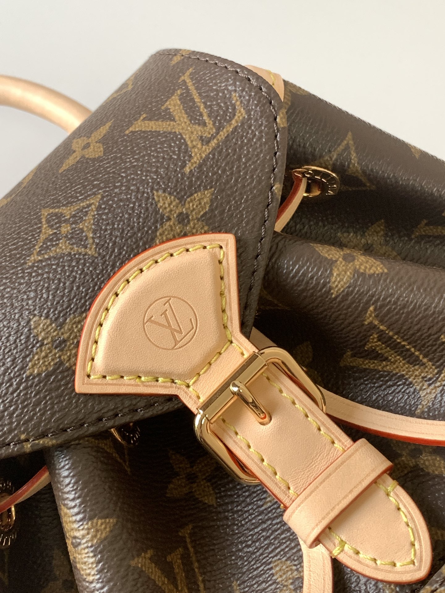 Louis Vuitton This Montsouris Mini features Monogram coated canvas with cowhide leather trim.