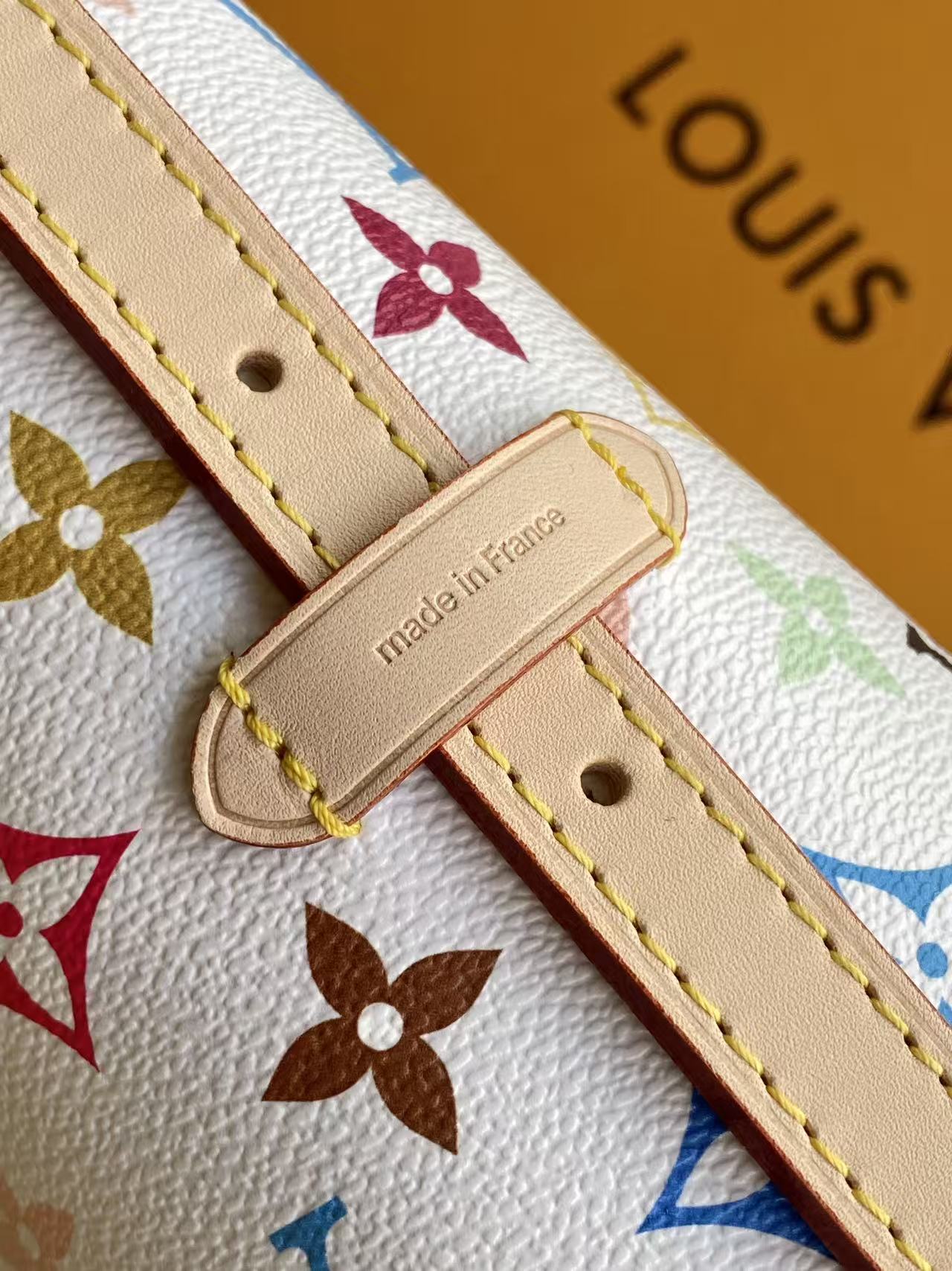 Louis Vuitton This Carryall East-West canvas handbag illuminates this classic element with a vibrant splash of color.